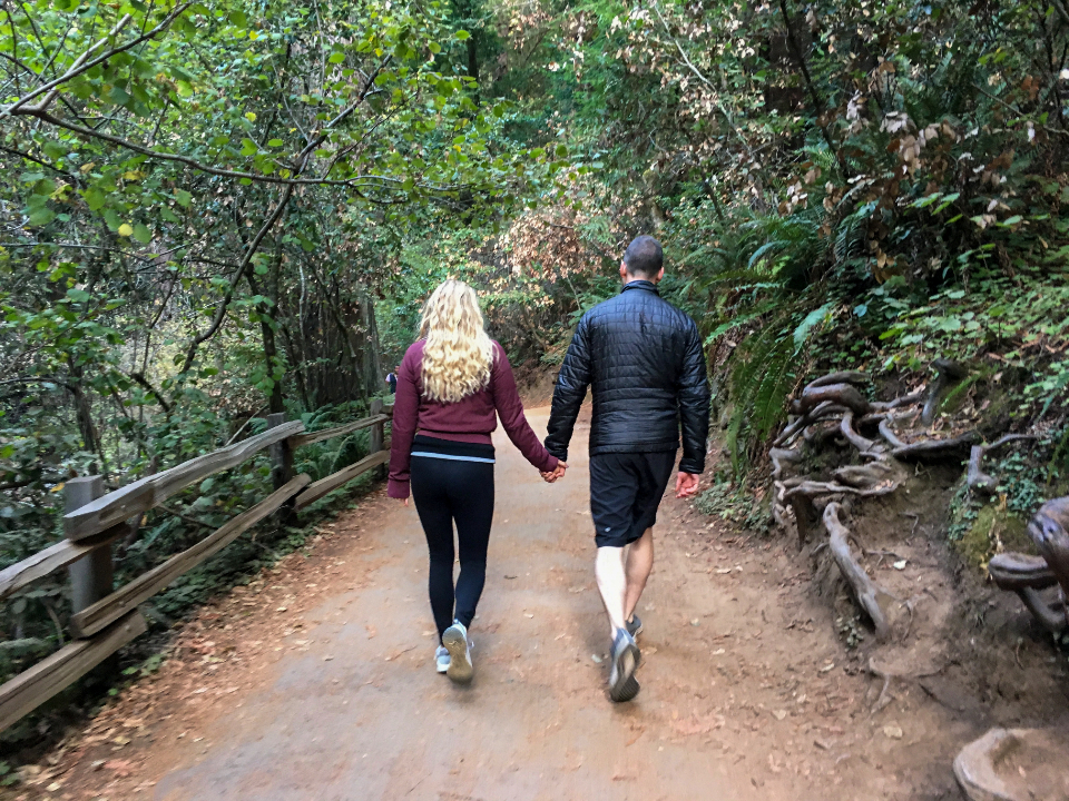 Couple walking together on a wooded trail