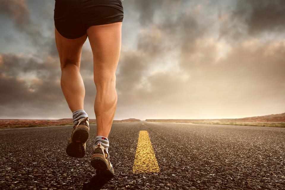 Runner on an open road at sunset
