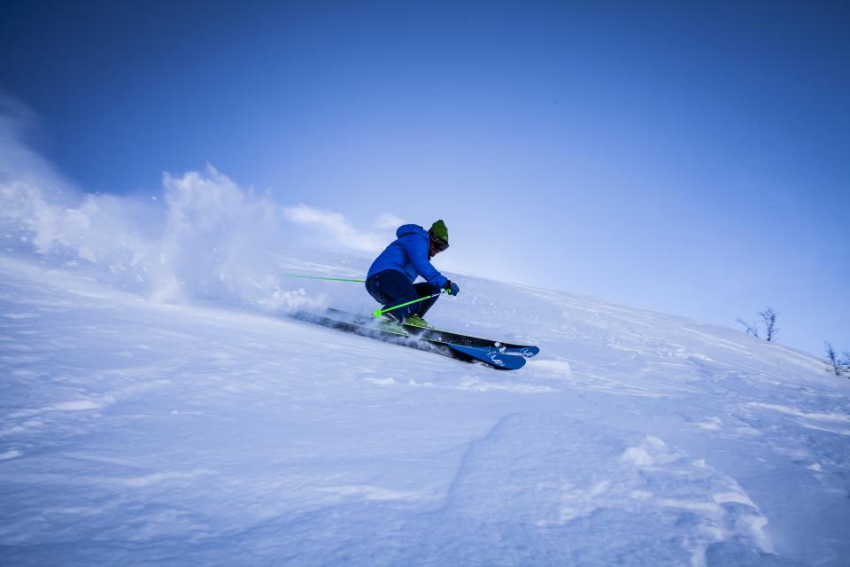 Skier carving through fresh snow