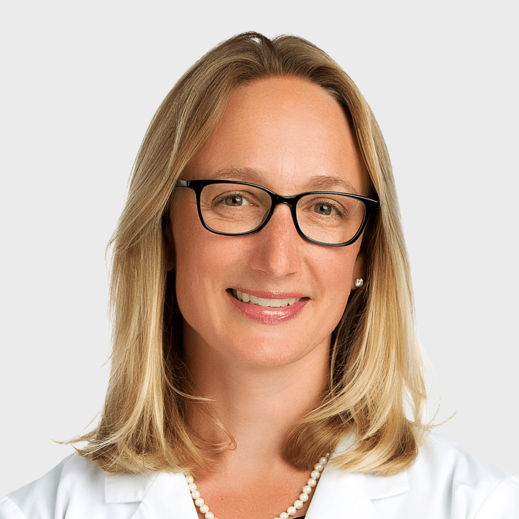 Dr. Katie Vadasdi, orthopaedic surgeon, in a white coat
